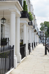 Row of beautiful white edwardian houses in Kensington, London