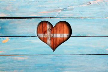 Love Denmark. Heart and flag on a blue wooden board