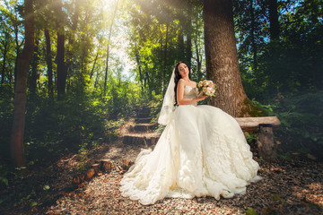 Bride in wedding dress in forest
