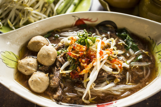 Thai noodle soup. Serve with Basil, bean Sprouts. (Kuay Tiew Ruer) Noodle and casseroled beef - Thailand food