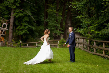 Bride going to groom in forest