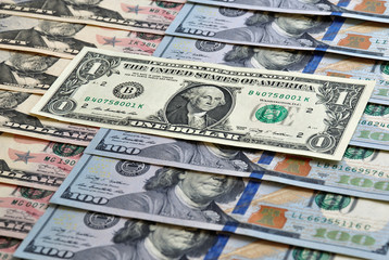 One dollar is on the other banknotes