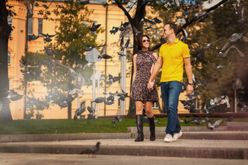 Fototapeta na wymiar Couple in park with doves