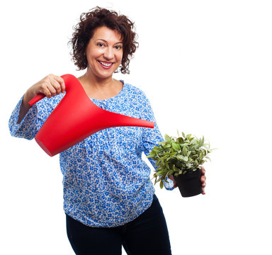 Portrait Of Mature Woman Watering A Plant