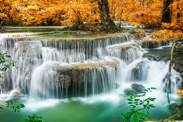 Fototapeta na wymiar Amazing waterfall in autumn forest 