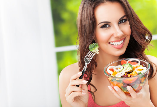 brunette woman with vegetarian vegetable salad