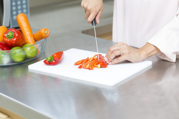 Closeup on woman cutting fresh vegetables