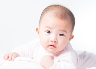 Adorable Asian baby 4-5 months old on white bed & background. Portrait studio light isolated.
