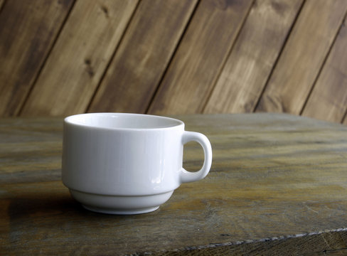 white cup on table on wooden background