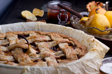 Apple/pear pie in a baking pan, with ingredients.