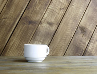 Fototapeta na wymiar white cup on table on wooden background