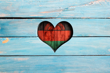 Love Malawi. Heart and flag on a blue wooden board