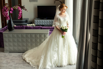 Fototapeta na wymiar Bride with bouquet in luxury interior
