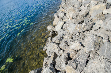 Mountain rock with blue water as background or texture wallpaper