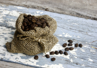 Coffee beans in bag on wooden table
