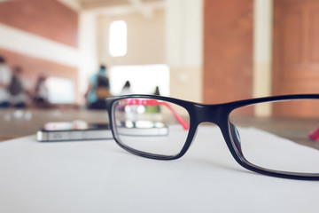 eye glasses placed on a blank paper sheet