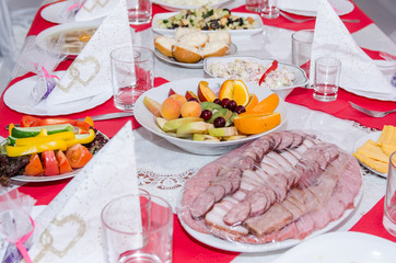 laid table with many dishes on white plates