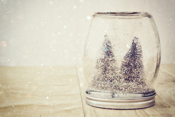selective focus image of christmas trees in mason jar.