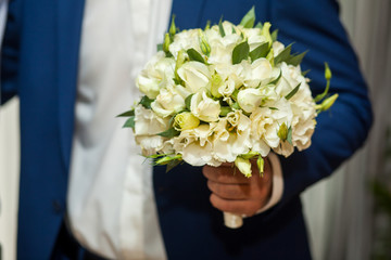  Groom holding wedding bouquet