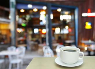 Blurred background : white cup of coffee and customer at restaur