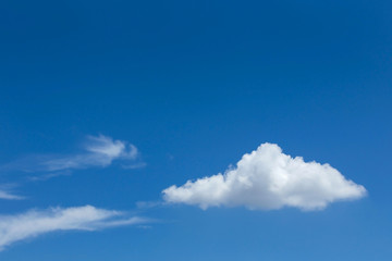 single cloud on clear blue sky background