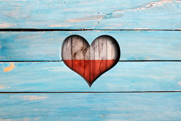 Love Poland. Heart and flag on a blue wooden board