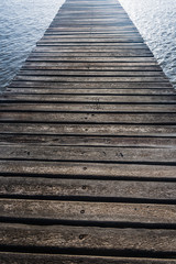 Fototapeta premium wooden bridge juts out into of the sea