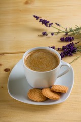 Top view on cup of coffee on white saucer