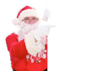 Kind Santa Claus pointing in white blank sign, isolated on white background