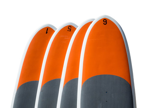 Four stand up paddle boards isolated against white