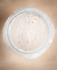 Sourdough natural yeast  in large  glass jar (top view)