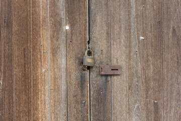 lock a door and Wood building surface and texture.
 lock on the door. lock on the door of an old farmhouse