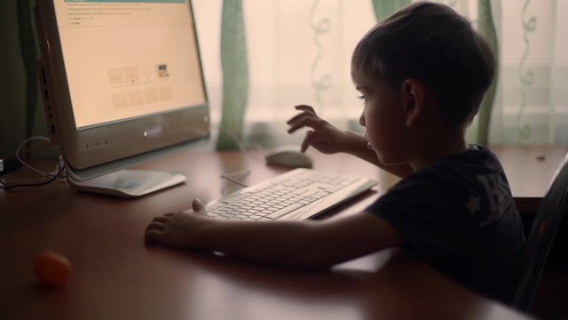little boy using computer, early education