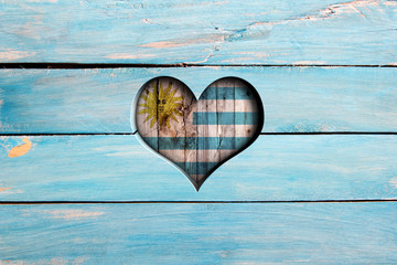 Love Uruguay. Heart and flag on a blue wooden board