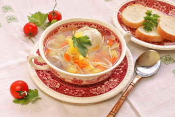 Chicken soup in vintage dish with parsley 