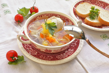 Chicken soup in vintage dish with parsley 