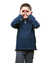 little kid doing a glasses gesture