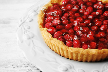 Tart with raspberries, on wooden background