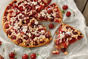 Tasty homemade pie with cherries on table close up