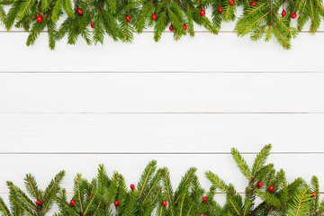 Fototapeta na wymiar Christmas background. Christmas fir tree with decoration on white wooden board background with copy space 