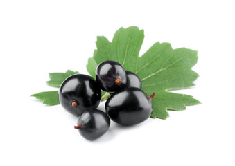 Heap of wild black currant with green leaves isolated on white