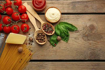 Pasta spaghetti with tomatoes, cheese and basil on rustic wooden  background