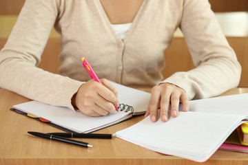 Female hand writing in notebook, close-up
