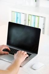 Fototapeta premium Man working with laptop in office