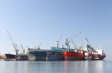 A large tanker repairs in dock. Shipyard