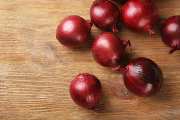 Red onion on wooden background