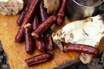 Grilled sausages on cutting board in the wood