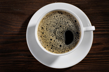 Cup of coffee on wooden background