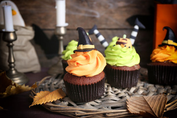 Halloween cupcakes on wicker mat on table