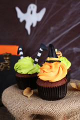 Halloween cupcakes and decoration on table